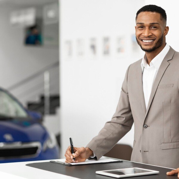 Square_Car Sales Manager Standing In Luxury Dealership Office